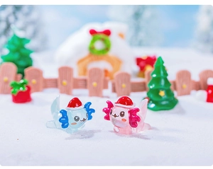 Miniature blue and pink Christmas axolotl figurines with Santa hats in a snowy micro landscape
