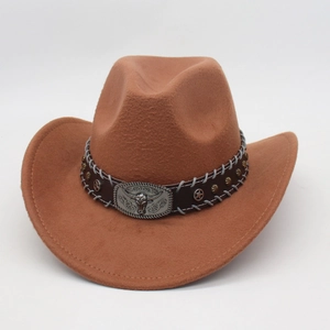 Detail of brown felt cowboy hat with leather band and vintage silver bull head buckle