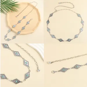 Detail of silver bohemian waist chain featuring turquoise inlays and diamond shapes
