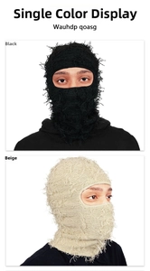 Close-up of distressed knit texture on black and beige balaclava with frayed edges