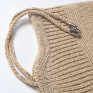 Winter khaki knitted earflap beanie for women with warm ribbed texture and metal tips