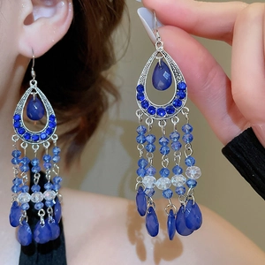 Macro shot of ethnic style long blue bead tassel earrings with droplet pendants
