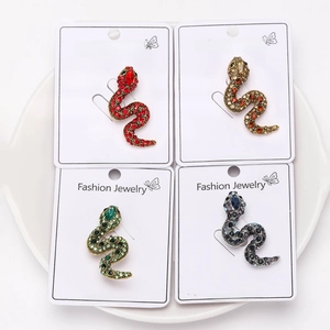 Set of four vintage snake brooches with colorful rhinestones on display cards