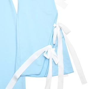 Close-up of soft light blue knit fabric with white ribbon lace-up detail on the side