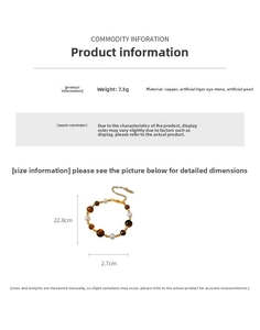 Detail of beaded bracelet with faux tiger eye, pearls, and gold-plated copper components