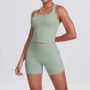Detail view of high-waist mint green yoga shorts with practical side pockets for fitness