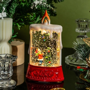 Lighted Christmas candle lamp with Santa snow globe scene and warm LED flame glow