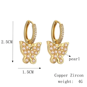 Detailed view of butterfly earrings with copper zircon and pearls, size 2.5cm by 1.5cm