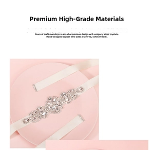 Detail of bridal sash with rhinestones and ivory ribbon on a soft pink display tray