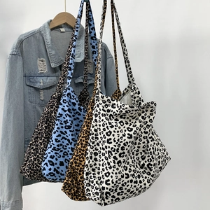 Detail showing four stylish leopard print canvas tote bags in different color patterns