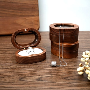 Detail view of oval walnut wood jewelry box with magnetic closure and clear window
