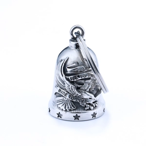 Macro shot of silver guardian bell with Live to Ride engraving and metal key ring loop