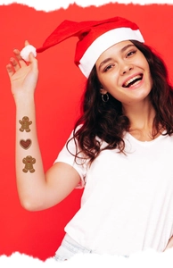 Detail showing Christmas gingerbread man and girl tattoo stickers on arm with festive vibe