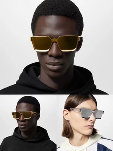 Detail of square vintage sunglasses with metallic frames and signature hinge design