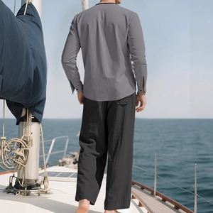 Men's linen vacation set featuring a grey long sleeve shirt and black wide-leg trousers
