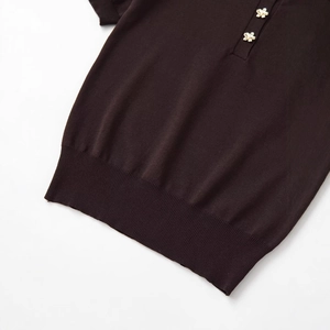 Short sleeve dark brown knit top with decorative gold floral buttons and ribbed hem
