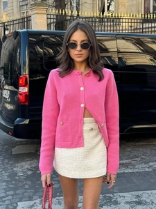 Elegant rose pink knit cardigan with gold buttons and white tweed skirt in street style