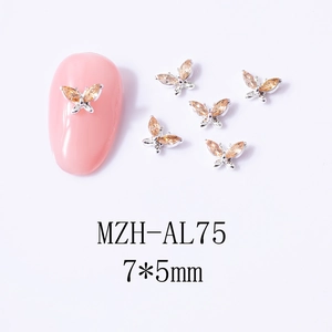 Close-up of 7x5mm champagne zircon butterfly nail charms on pink manicure tips