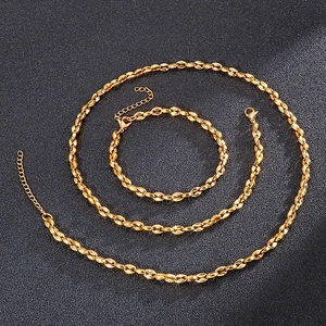 Detailed close-up of golden geometric rice grain link necklace and bracelet set