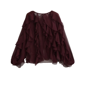 Detail view of the layered ruffles and sheer chiffon fabric on a burgundy long sleeve blouse