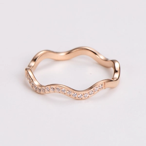 Detail of rose gold wave ring featuring micro-pave white cubic zirconia accents