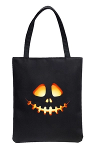 Halloween tote bag with glowing orange pumpkin face print on high-quality black canvas