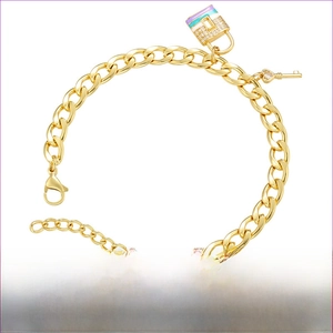 Detail of gold brass bracelet featuring a colorful enamel lock and heart key with zircons