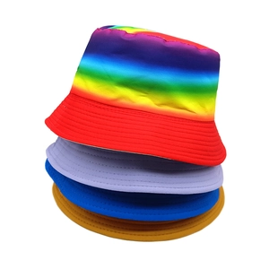 Close-up of stacked colorful cotton sun hats showing rainbow and solid color designs