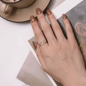 Minimalist S925 sterling silver airplane ring with zircon accents on a model's hand