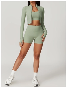 Detailed close-up of sage green high-waist yoga shorts with thumb-hole athletic jacket