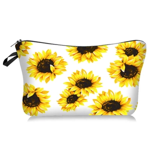 Détail d'une trousse à maquillage à motif tournesol avec fermeture éclair et sangle noire