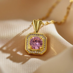 Elegant gold-plated square pink zircon pendant necklace with pavé crystal halo on beige fabric