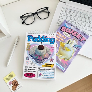 Flat lay of vintage cartoon spiral notebooks with pudding and rabbit motifs on desk