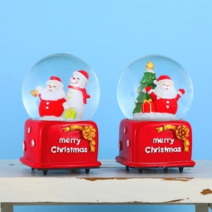 Christmas musical snow globes with Santa and snowman on a festive red base
