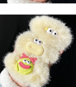 Close-up of three cute plush hair clips with cartoon eyes and funny yellow duck beaks