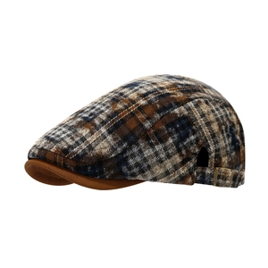 Vintage tie-dye plaid flat cap with brown brim and metal buckle viewed from 45 degrees