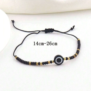 Detail of adjustable black woven devil's eye bracelet with 14cm to 26cm length range