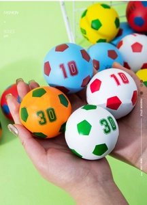 Detailed view of 6cm colorful mini football stress balls held in hand for scale