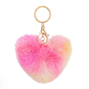 Detailed close-up of a gradient pink and yellow plush heart-shaped keychain with gold ring