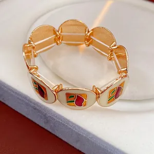 Vintage gold stretch bracelet with geometric enamel charms in red and green for women