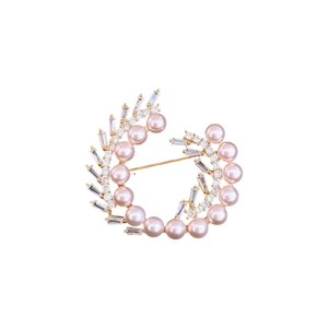 Elegant gold plated circular brooch with pink pearls and baguette-cut cubic zirconia crystals