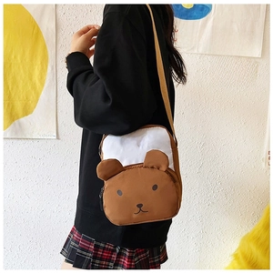 Detailed view of the brown bear crossbody bag featuring a cute cartoon face and adjustable strap