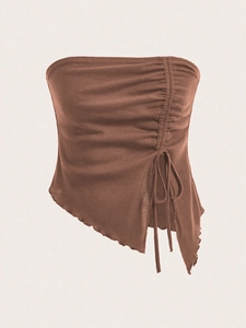 Detail of waffle knit tube top featuring side drawstring ruching and irregular hemline