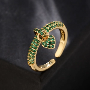 Adjustable 18K gold ring with micro-paved green zircons and a heart pendant on dark stone