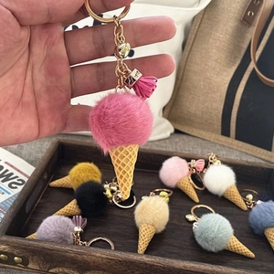 Handheld cute ice cream plush keychain with pink pompom and yellow cone charm