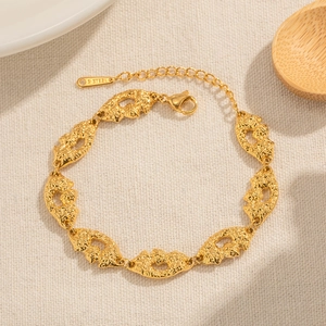 Detail of 18K gold plated stainless steel bracelet with lava texture and lobster clasp