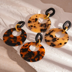 Chic leopard print resin circle drop earrings with gold metal accents on white stone