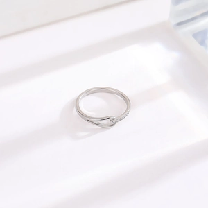 Detail of minimalist silver-toned titanium steel ring with sparkling pavé zircons