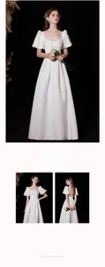 Detail of square neckline with bubble sleeves and pearl embellishments on a white dress