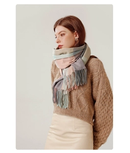 Close-up of elegant plaid cashmere-like scarf with fringe detail and soft texture